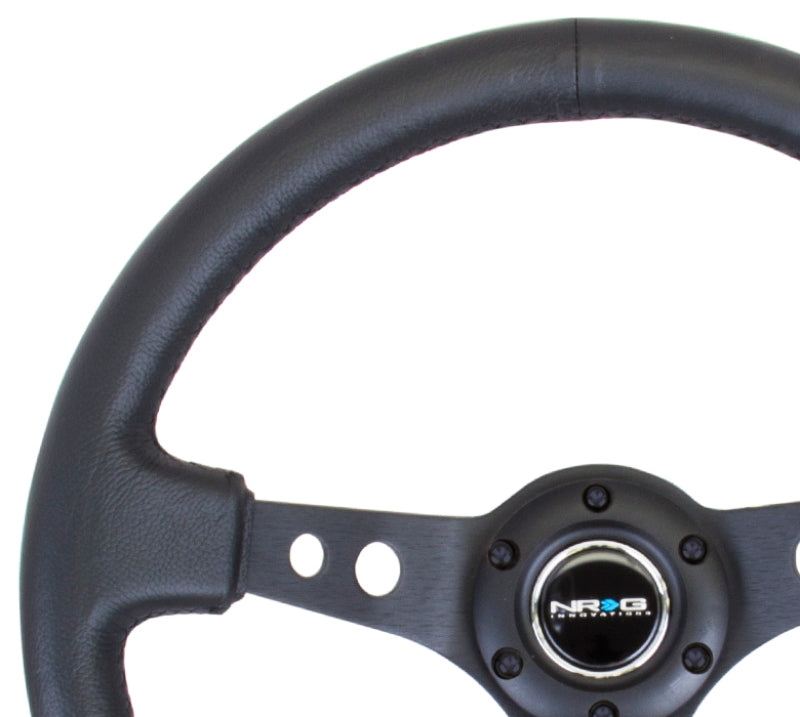 NRG Reinforced Steering Wheel (350mm / 3in. Deep) Blk Leather w/Blk Spoke & Circle Cutouts - Blais Performance Parts